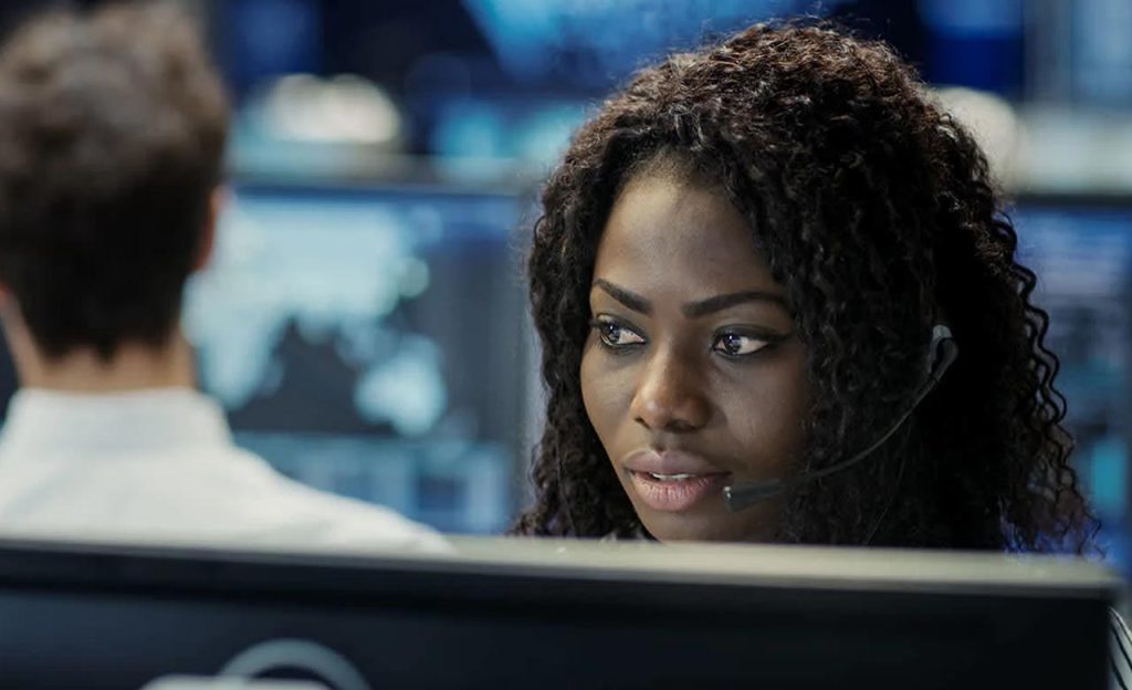 Taxi dispatcher with a headset working at a dispatch desk